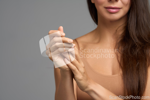 Image of Woman touching her hands symbolizing self care, softness and skin nourishment