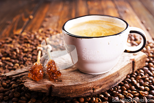 Image of Cup of coffee on wooden background.