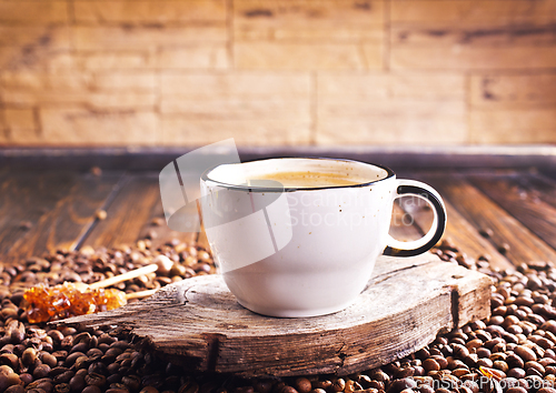 Image of Cup of coffee on wooden background.