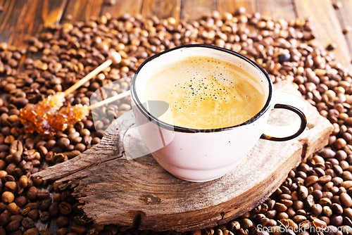 Image of Cup of coffee on wooden background.