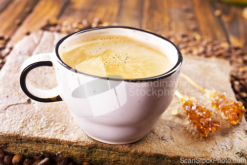 Image of Cup of coffee on wooden background.