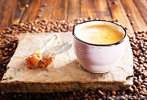 Image of Cup of coffee on wooden background.