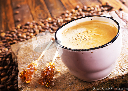 Image of Cup of coffee on wooden background.