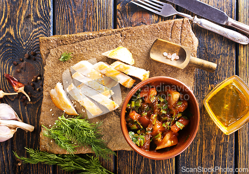 Image of chicken fillet on board with vegetable stew in bowl