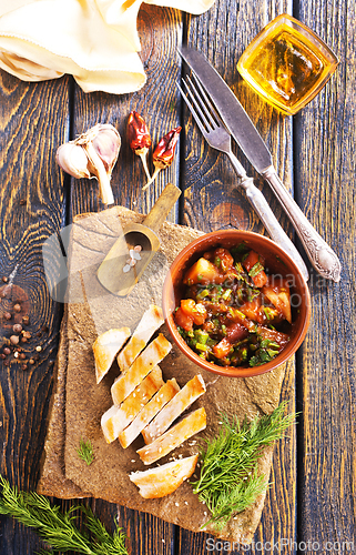 Image of chicken fillet on board with vegetable stew in bowl