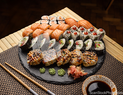 Image of Assorted sushi arranged on a slate platter