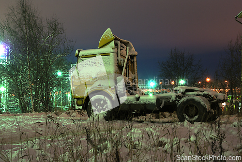 Image of old truck parked at night 