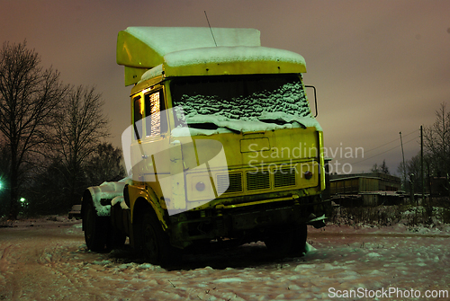 Image of old truck parked at night 