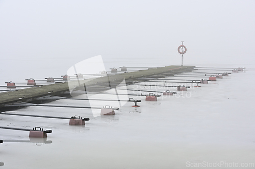Image of empty boat dock on the lake in winter 