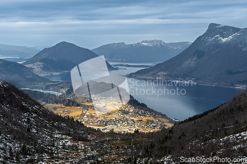 Image of Scenic view of a tranquil valley surrounded by majestic mountain