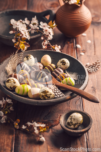 Image of Easter place setting with sweet chocolate eggs, spring celebration