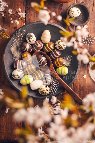 Image of Easter place setting with sweet chocolate eggs, spring celebration