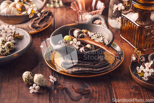 Image of Easter place setting with sweet chocolate eggs, spring celebration