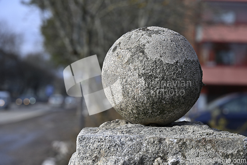 Image of old granite ball covered with moss