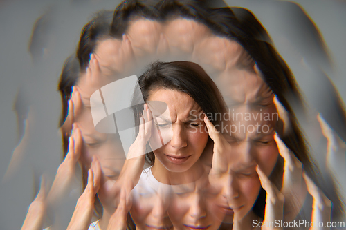 Image of Woman suffering from headache or migraine with multiple exposure effect
