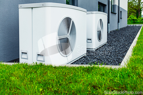 Image of Air source heat pumps installed outside of new and modern city house