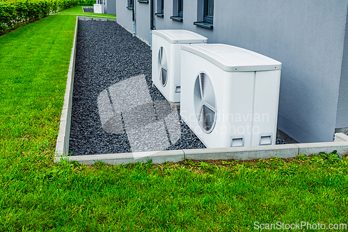 Image of Air source heat pumps installed outside of new and modern city house