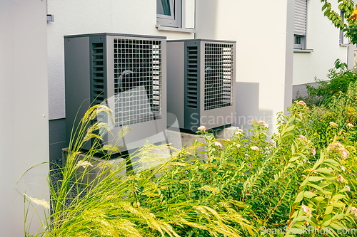 Image of Air source heat pumps installed outside of new and modern city house