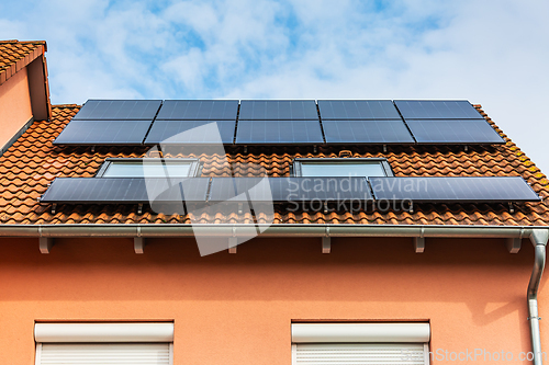 Image of New solar panels installed on sheet roof of modern house