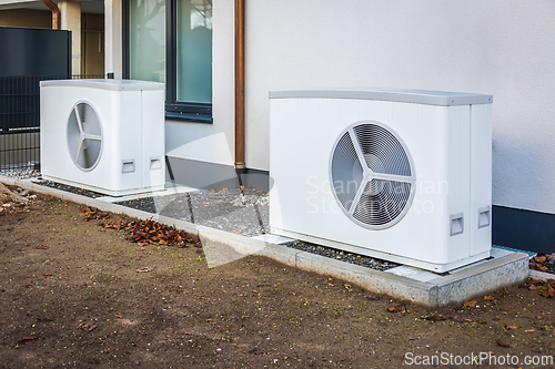Image of Air source heat pump installed outside of new and modern city house