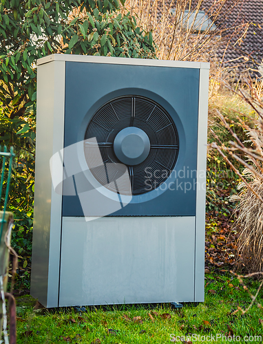 Image of Air source heat pump installed outside of new and modern city house