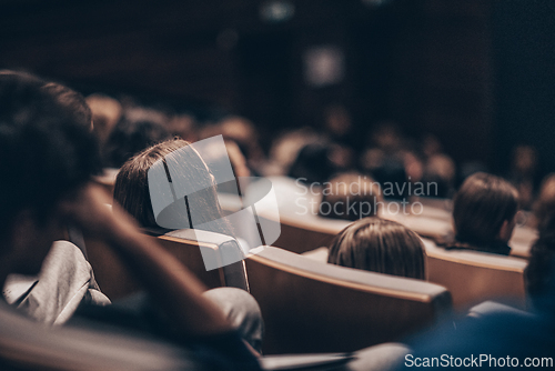 Image of Rear view of unrecognizable people in audience at the conference hall. Business and entrepreneurship symposium.