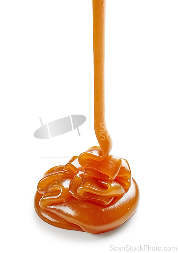 Image of caramel sauce pouring on white background