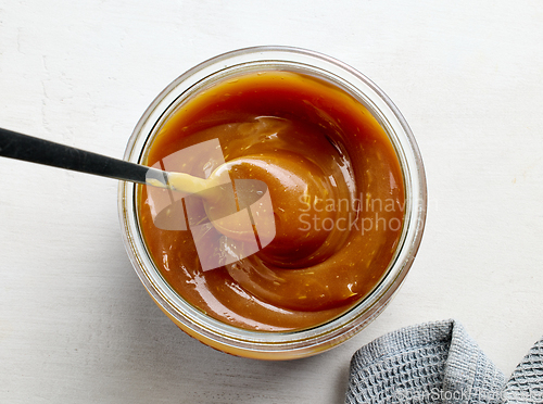 Image of glass jar of freshly cooked homemade caramel sauce
