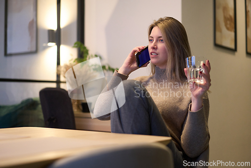 Image of Calm Phone Call with a Glass of Water at the Table