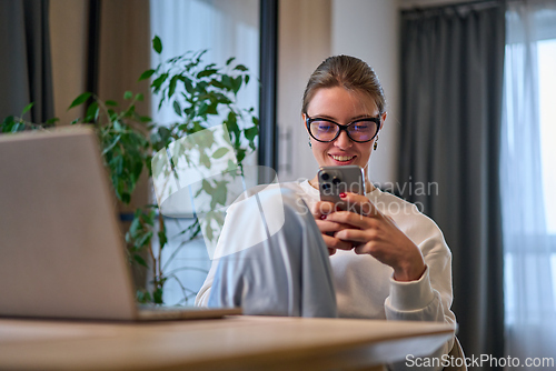 Image of Relaxed Break With Her Feet Up in a Sunlit Dining Space