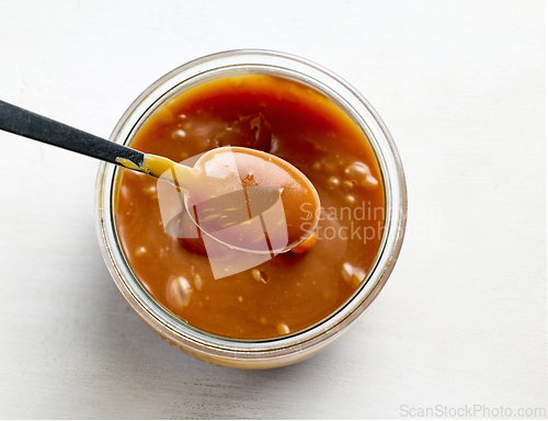 Image of freshly cooked homemade caramel sauce in jar