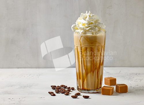 Image of glass of caramel latte with whipped cream