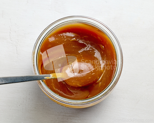 Image of freshly cooked homemade caramel sauce in jar
