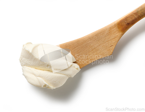 Image of fresh cream cheese on wooden knife