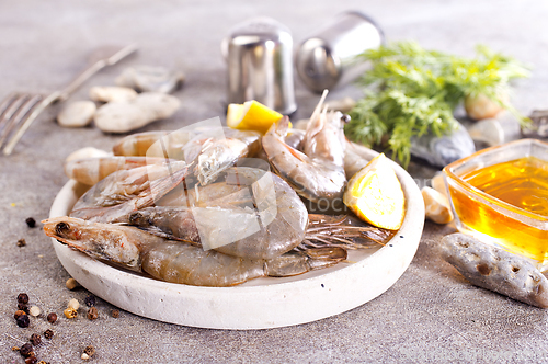 Image of Uncooked Raw peeled tiger white shrimp prawn. Gray background.