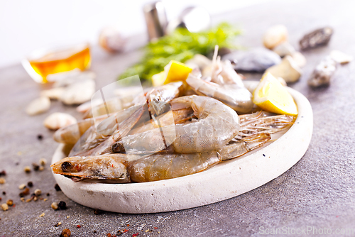 Image of Uncooked Raw peeled tiger white shrimp prawn. Gray background.