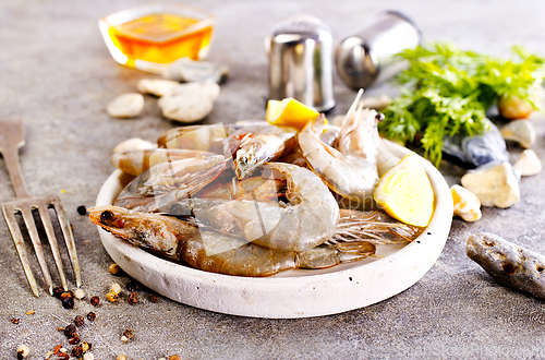 Image of Uncooked Raw peeled tiger white shrimp prawn. Gray background.