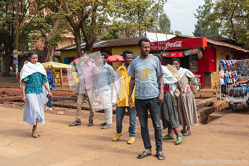 Image of View of the town center, where people and small market stalls operate on the dirt road. Fenote Selam, Ethiopia