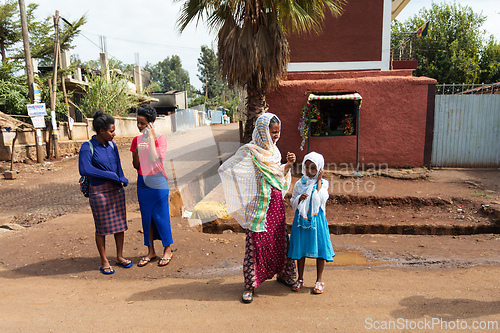 Image of Women of Fenote Selam gather by the roadside, showcasing both traditional Ethiopian shawls and modern fashion.