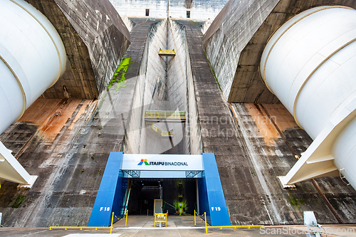 Image of Central access portal beneath the enormous concrete face of the Itaipu Binacional Hydroelectric Dam. Itaipu Binacional, Brazil