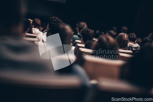 Image of Rear view of unrecognizable people in audience at the conference hall. Business and entrepreneurship symposium.