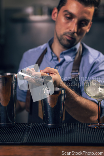 Image of Professional bartender pouring spirit
