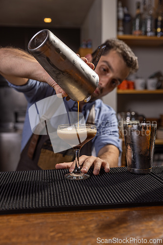 Image of Bartender pouring espresso martini