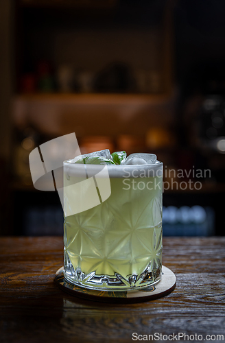 Image of Basil cocktail on wooden bar