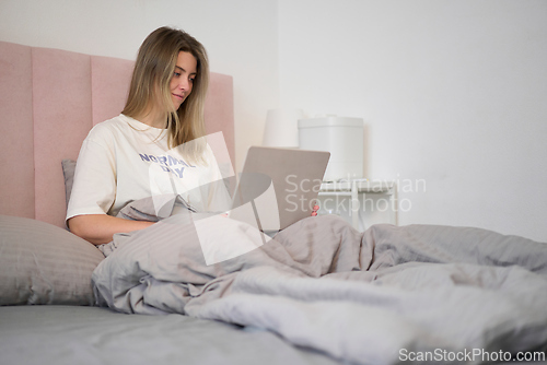 Image of Comfortable Bedside Work with Soft Natural Light