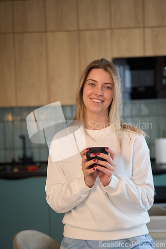 Image of Warm Smile Over a Morning Cup in a Modern Kitchen