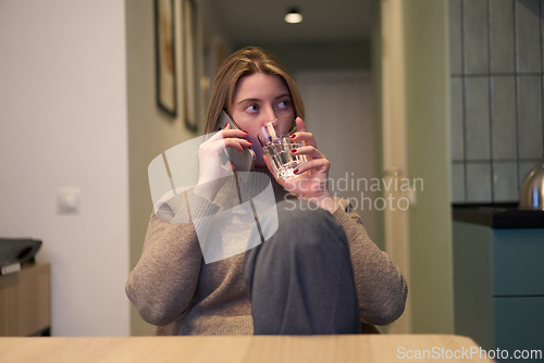 Image of Focused Phone Conversation in a Bright Home Interior
