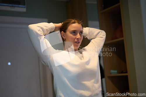 Image of Focused Hair Styling Quietly Framed by Soft Interior Light