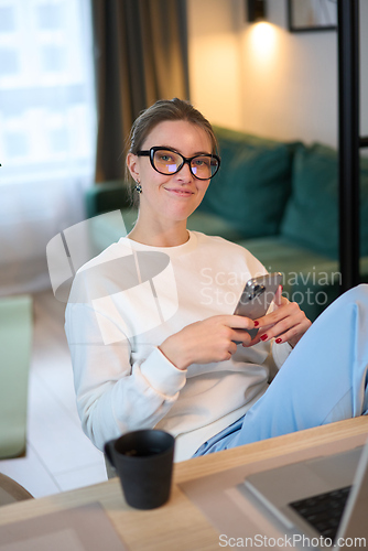 Image of Gentle Pause While Checking Messages at Home