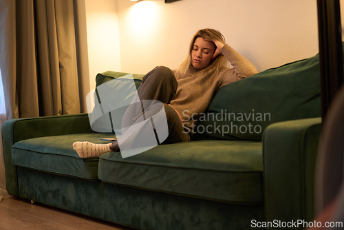 Image of Resting on a Green Sofa in Soft Evening Light